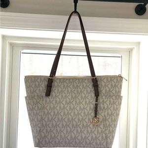 White signature tote w/brown leather strap and gold zipper. New without tag.